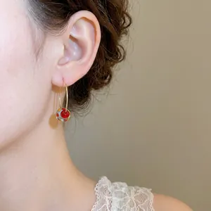 Minimalist gold hoop earrings featuring resin colorful polka dot spherical charms