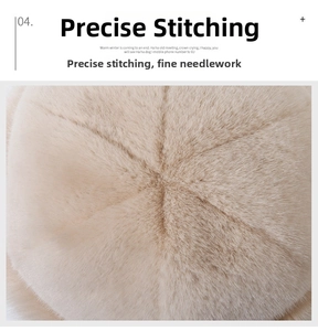 Detailed view of reinforced cross-stitching on the plush beige faux fur winter hat crown