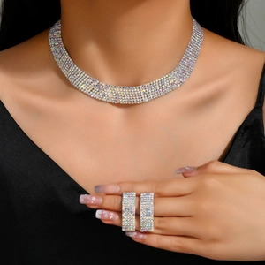 Detailed view of luxury bridal rhinestone choker and rectangular earrings set on a model