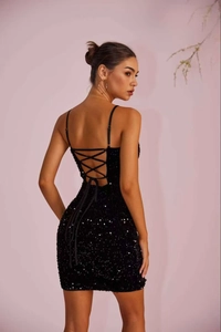 Close-up of sexy backless evening dress with sequin detail and crisscross tie straps