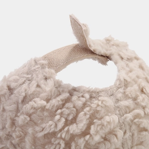 Close-up of the beige plush baseball cap featuring an adjustable velcro strap back