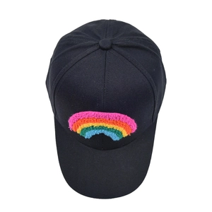 Detailed macro view of vibrant rainbow chenille embroidery on a black cotton baseball cap