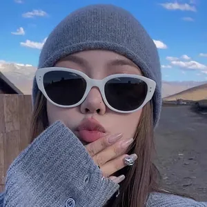 Close-up of white oval frame polarized sunglasses with chic vintage cat-eye design