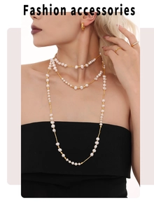 Detail of layered freshwater pearl necklace and gold earrings on model fashion set