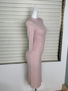 Detail view of pink ribbed knit midi dress showing the slim fit texture on a mannequin