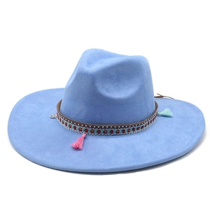 Detail of light blue wide brim fedora hat featuring ethnic woven band and colorful tassels