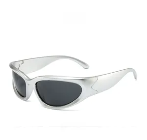 Close-up of silver Y2K cycling sunglasses with steampunk frame and dark sport lenses