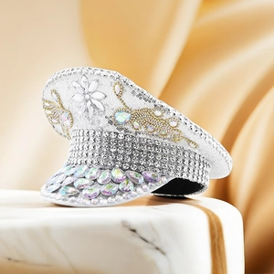 Close-up of white sequined captain hat featuring large rhinestones and floral crystals