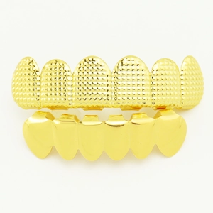 Detail of gold-plated hip hop grillz set featuring textured top and smooth bottom teeth