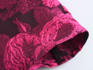 Macro shot of sweet style floral jacquard fabric and stitching detail on dress cuff