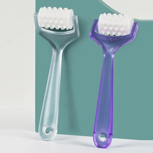 Close-up of ergonomic facial roller with serrated head in light blue and purple