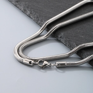 Macro detail of silver stainless steel snake chain necklace with lobster clasp closure