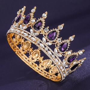 Detailed view of luxury gold crown featuring purple teardrop gems and sparkling rhinestones