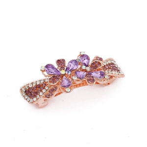 Detailed shot of alloy flower hair clip with purple rhinestones on a white background