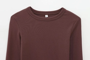 Macro shot of dark coffee crew neck and knit fabric texture of long sleeve t-shirt