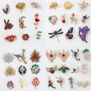 Assorted enamel brooches with animal and floral designs featuring rhinestones and pearls