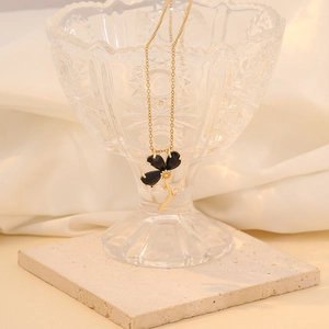 Elegant gold-plated necklace featuring a black flower pendant with sparkling zircon accents