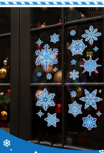 Close-up of blue snowflake static window stickers with holographic glitter and star decals