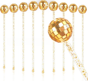 Macro view of gold disco mirror ball cocktail stirrers with glitter acrylic sticks