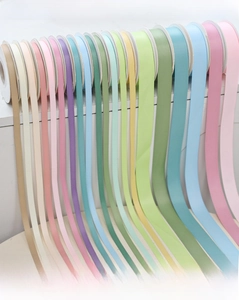 Rainbow macaron ribbons in pink blue and yellow for gift wrapping and DIY crafts