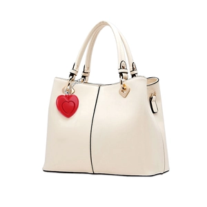 Off-white faux leather tote bag with a red heart pendant and gold metal hardware