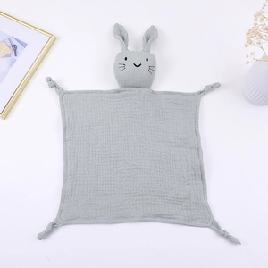 Close-up of grey bunny cotton gauze baby comforter blanket with knotted corners and soft texture