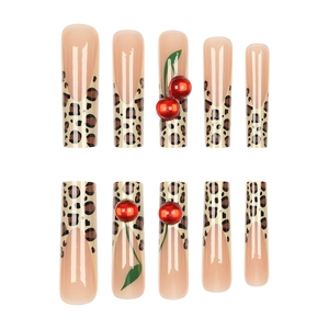 Extra long French leopard print false nails with cherry 3D accents on white background