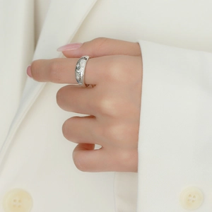 Detail of silver star and moon engravings on a wide S925 sterling silver open ring