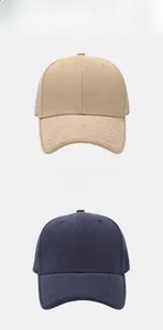 Close-up of khaki and navy cotton baseball caps with curved brims and six-panel design