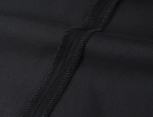 Detail of high-density black twill fabric with reinforced zigzag stitching on the seam