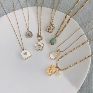 Set of seven gold titanium steel necklaces with butterfly and heart shell pendants