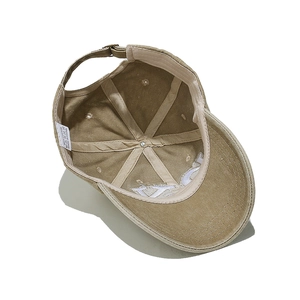 Close-up of khaki baseball cap interior showing 100% cotton label and neat stitching
