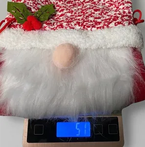 Detailed close-up showing a 51g gnome Christmas gift bag on an electronic scale
