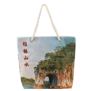 Sky blue canvas tote bag featuring elephant trunk hill scenery and rope handles