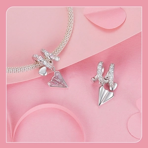 Detailed shot of S925 silver paper plane pendant with pink and white cubic zirconia