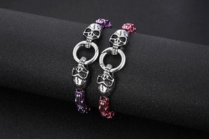 Macro shot of mechanical skull bracelets in metallic purple and rose pink finishes
