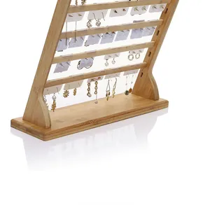 Detail view of tiered natural bamboo earring display stand with slots and a solid wood base