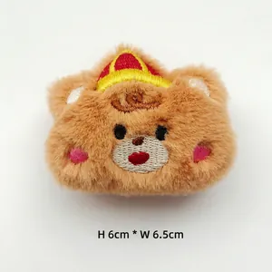 Detailed view of a brown plush bear accessory with a crown, size 6cm by 6.5cm