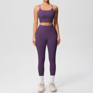 Front view of deep purple yoga set featuring thin strap sports bra and high waist leggings