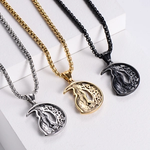Viking wolf moon necklaces in gold, silver, and black finishes on geometric stands