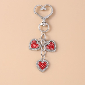 Detail view of silver heart keychain with sparkling red and white rhinestones