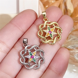 Detail of star-shaped pendants with colorful cubic zirconia in gold and silver finishes