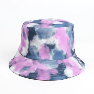Detail of double-sided tie-dye bucket hat featuring pink and blue cotton fabric patterns