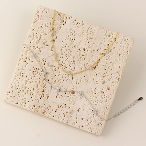 S925 sterling silver clover bracelets in gold and silver finish on stone display