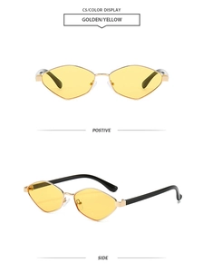 Detail view of gold metal sunglasses with geometric yellow lenses and black temple tips