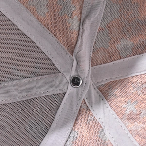 Detailed close-up of baseball cap interior showing mesh fabric and silver star print