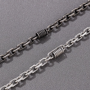 Detail of vintage biker chain necklace in oxidized and polished stainless steel