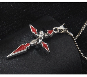 Macro shot of silver stainless steel cross pendant with red enamel detailing on leather