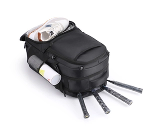 Detail of waterproof sports backpack showing dedicated shoe compartment and racket pocket