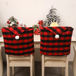 Christmas buffalo plaid chair covers set with white pom pom decorations in a festive room